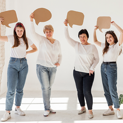 4 women holds dialogue cardboard